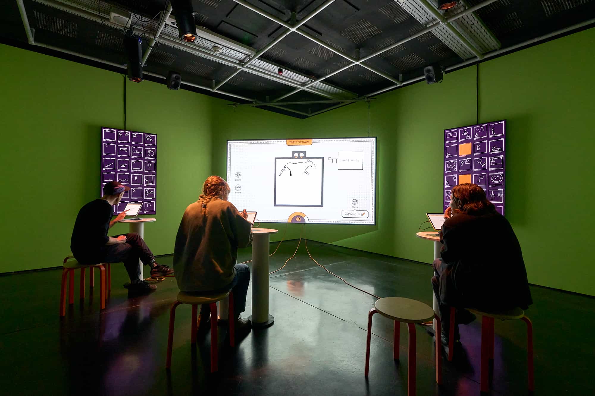 People playing outdraw.AI around a large projector screen at FACT Liverpool